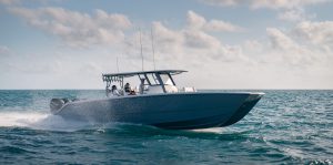 Man navigating the 40 ft. Catamaran, a twin-hulled offshore fishing and boating machine.